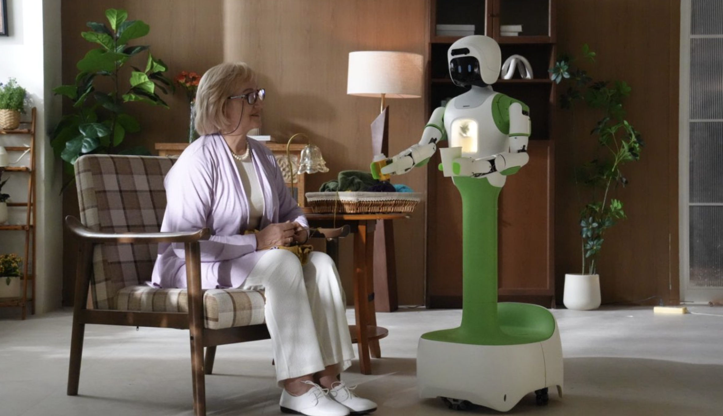 KOKO robot interacting with an older adult at home.